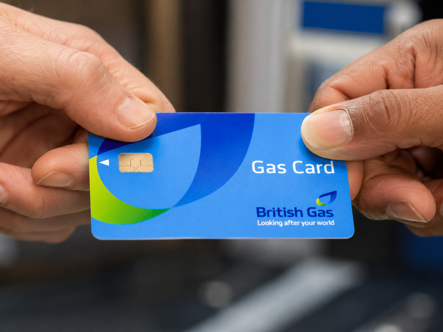 A British Gas prepayment gas card being handed between two people