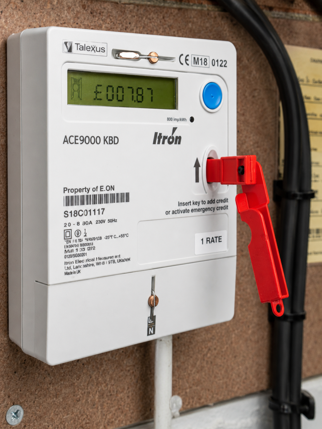 A prepayment electricity meter with a red key slot for adding credit