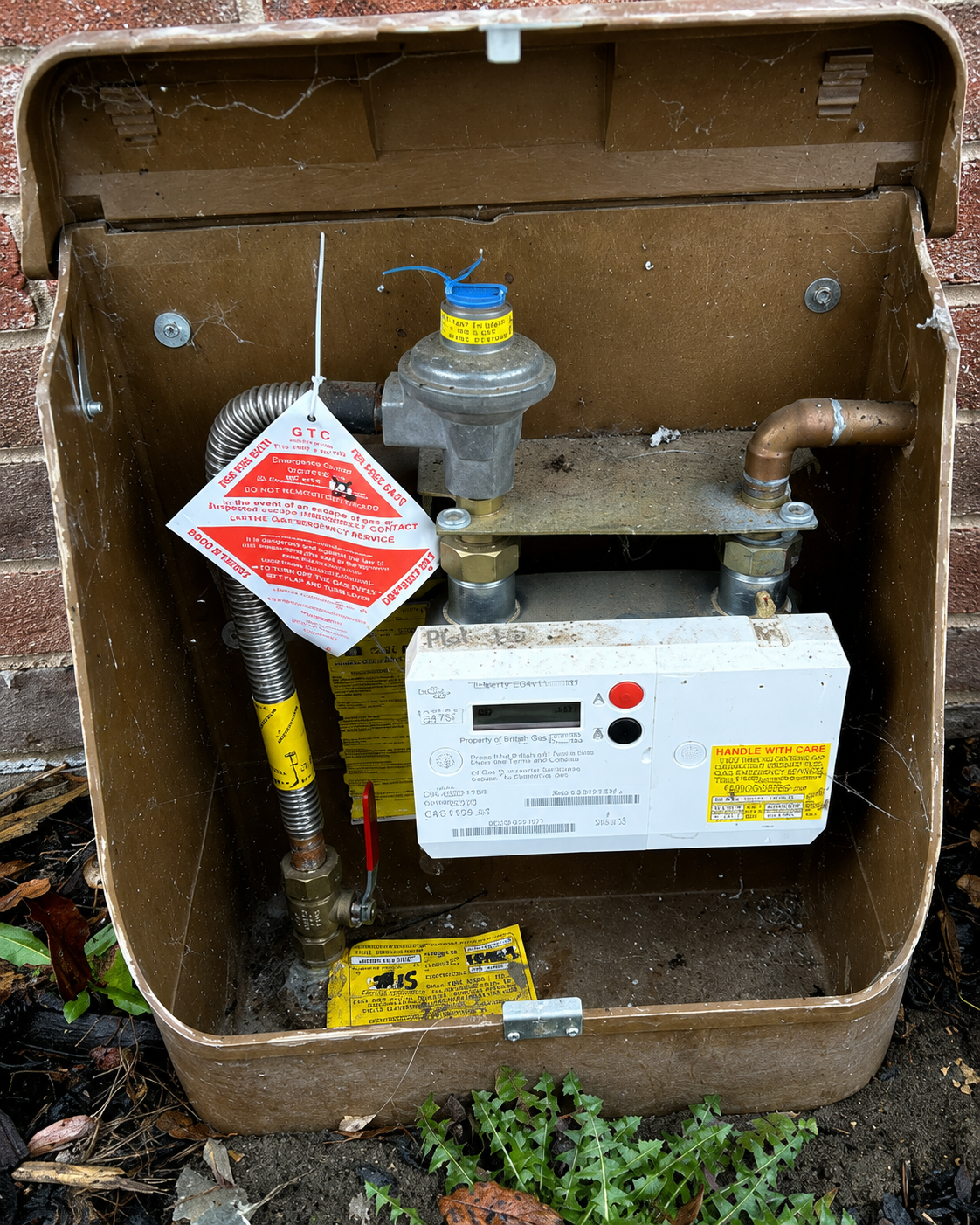 Open gas meter box showing a British Gas prepayment smart meter installation
