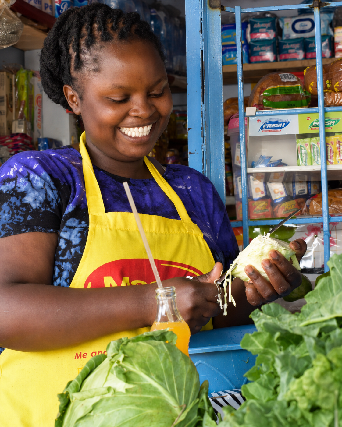 Shopkeeper preparing fresh produce at a local store